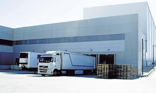 Trucks unload goods in the warehouse as part of cross-docking operations