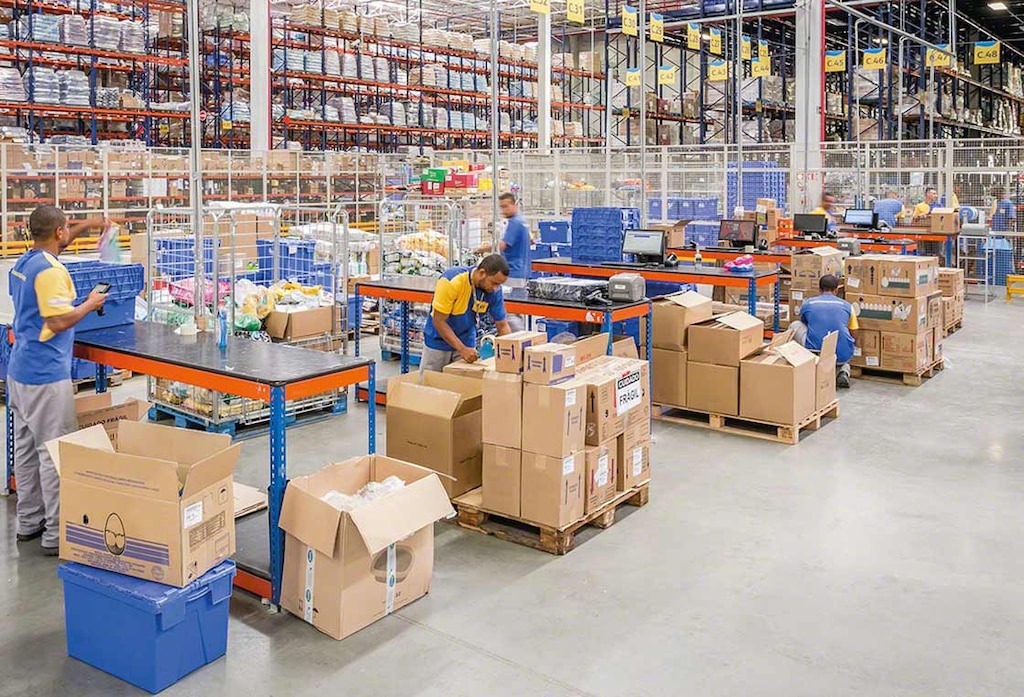 Employees working as a team in a warehouse Employees working as a team in a warehouse