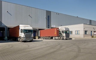 Lorries loading and unloading goods at the warehouse docks