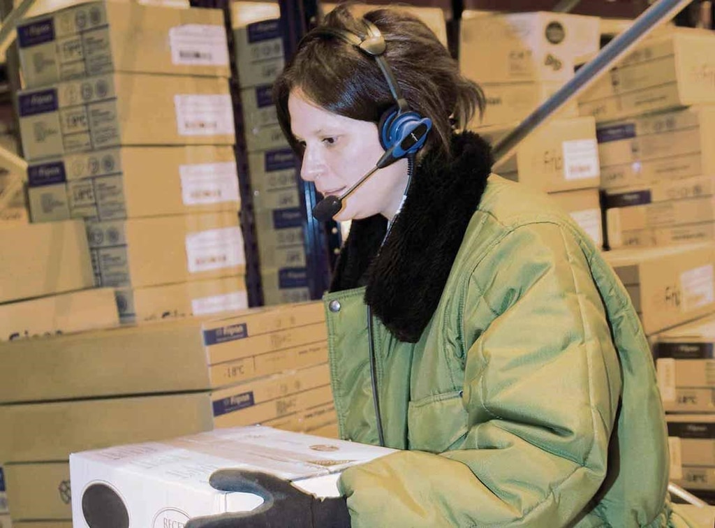 An operator performs order picking tasks with a voice picking system An operator performs order picking tasks with a voice picking system