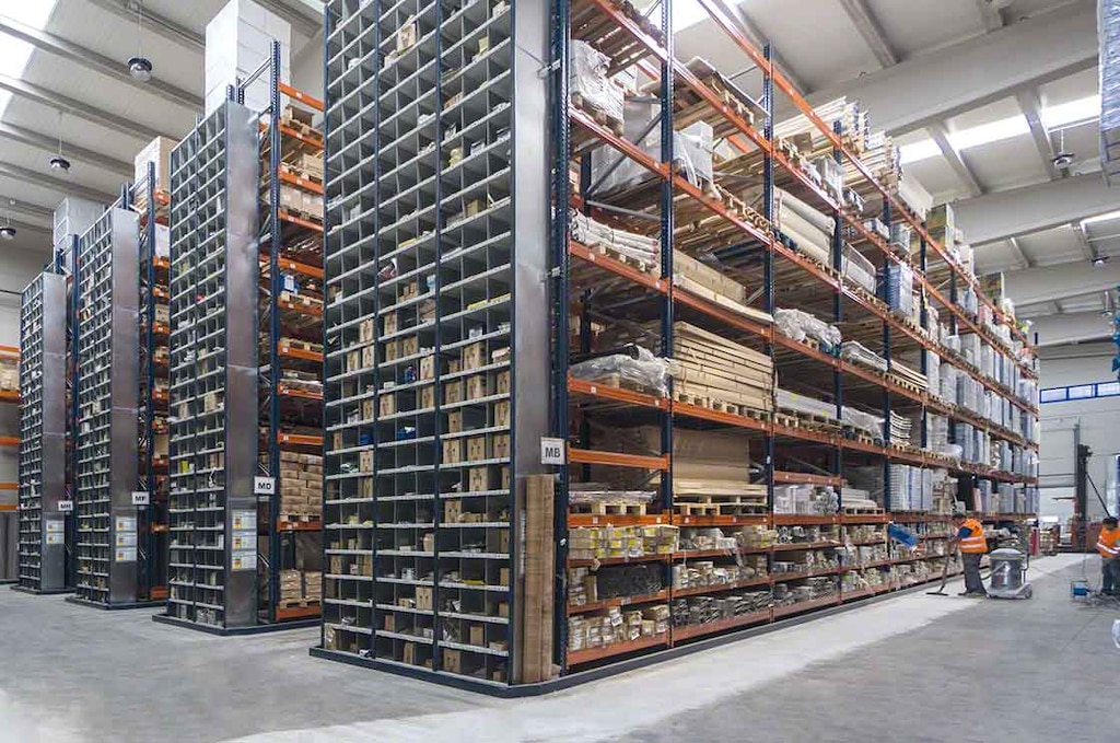 Operators perform cleaning tasks in a warehouse with pallet racking Operators perform cleaning tasks in a warehouse with pallet racking
