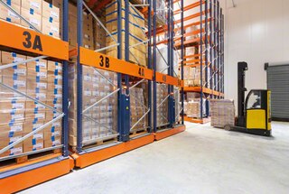 The forklift enters the open aisle in the mobile racking to deposit or remove the pallet