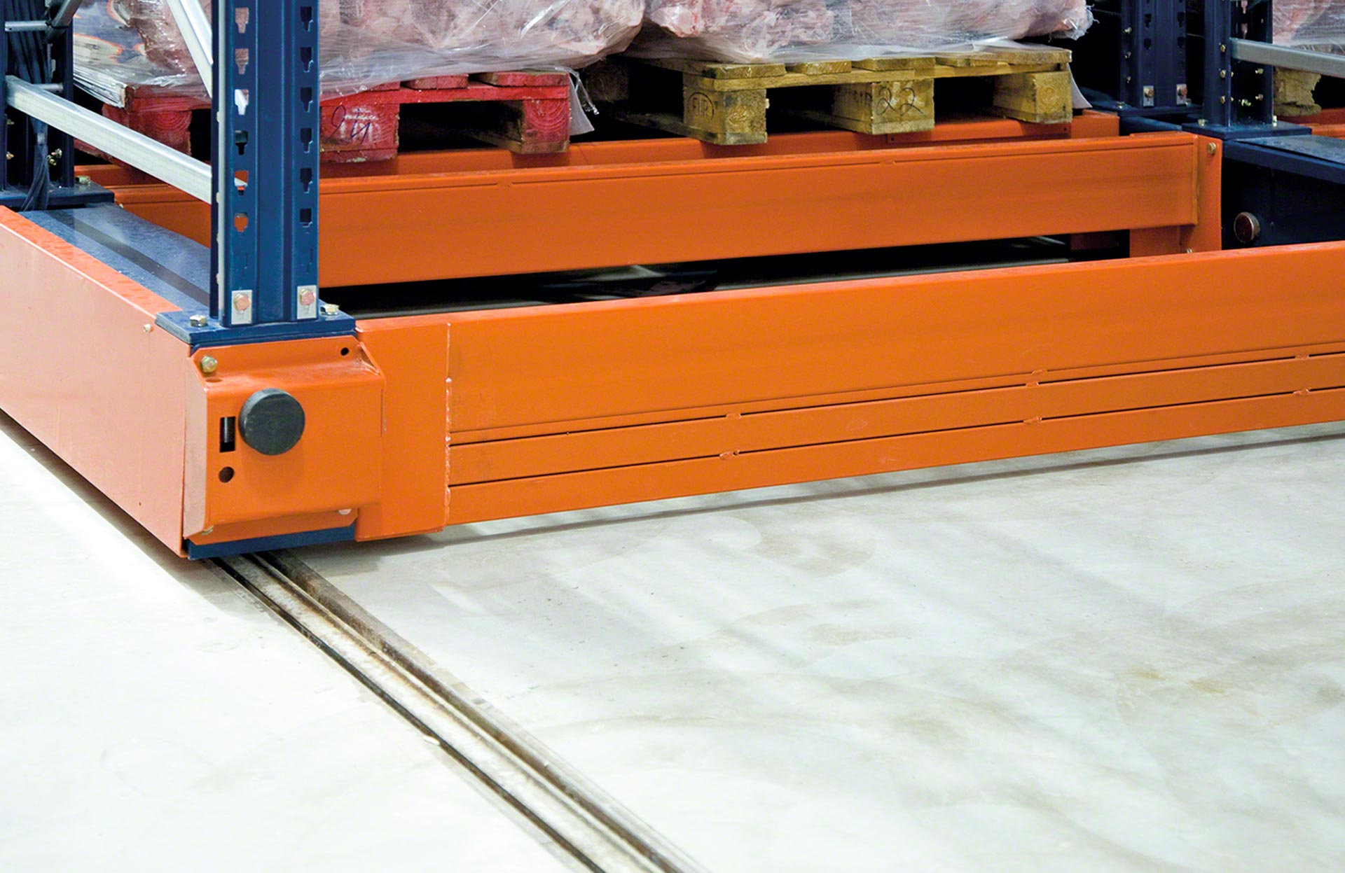 The racks are mounted on mobile bases that move along rails embedded in the floor