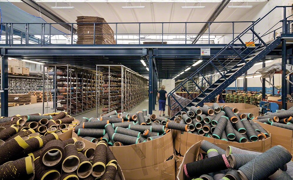 Mezzanine with hinged safety gate lets forklifts distribute loads between levels Mezzanine with hinged safety gate lets forklifts distribute loads between levels