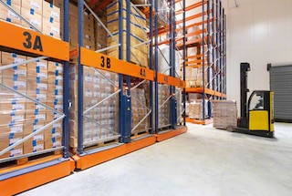 The forklift enters the open aisle in the mobile racking to deposit or remove the pallet