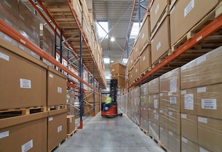 A forklift unloads a pallet from selective pallet racking