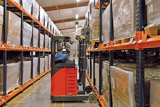 The forklift deposits the first pallet at the beginning of the channel of a push-back rack