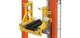 The stacker crane’s lifting cradle moves loads vertically