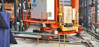 Stacker cranes can also change aisles via the curved track system