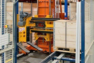 The stacker crane moves the retrieved pallet to the end of the aisle