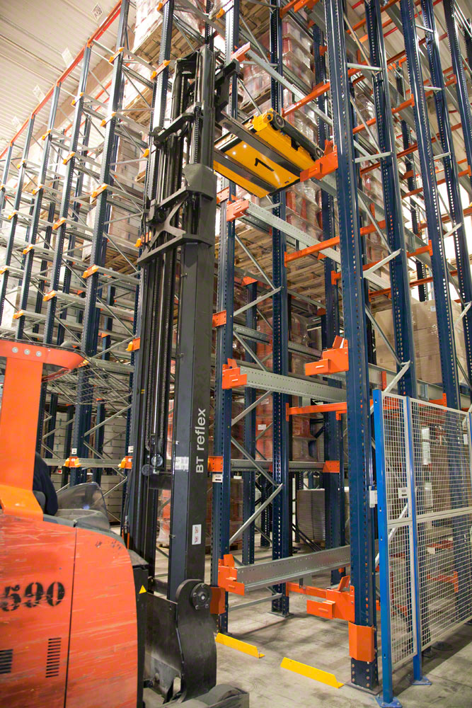 An operator handling a Pallet Shuttle with a reach truck